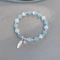 Small white girl crystal bracelet with feather XINGX blue moonlight colour and eight awn star details
