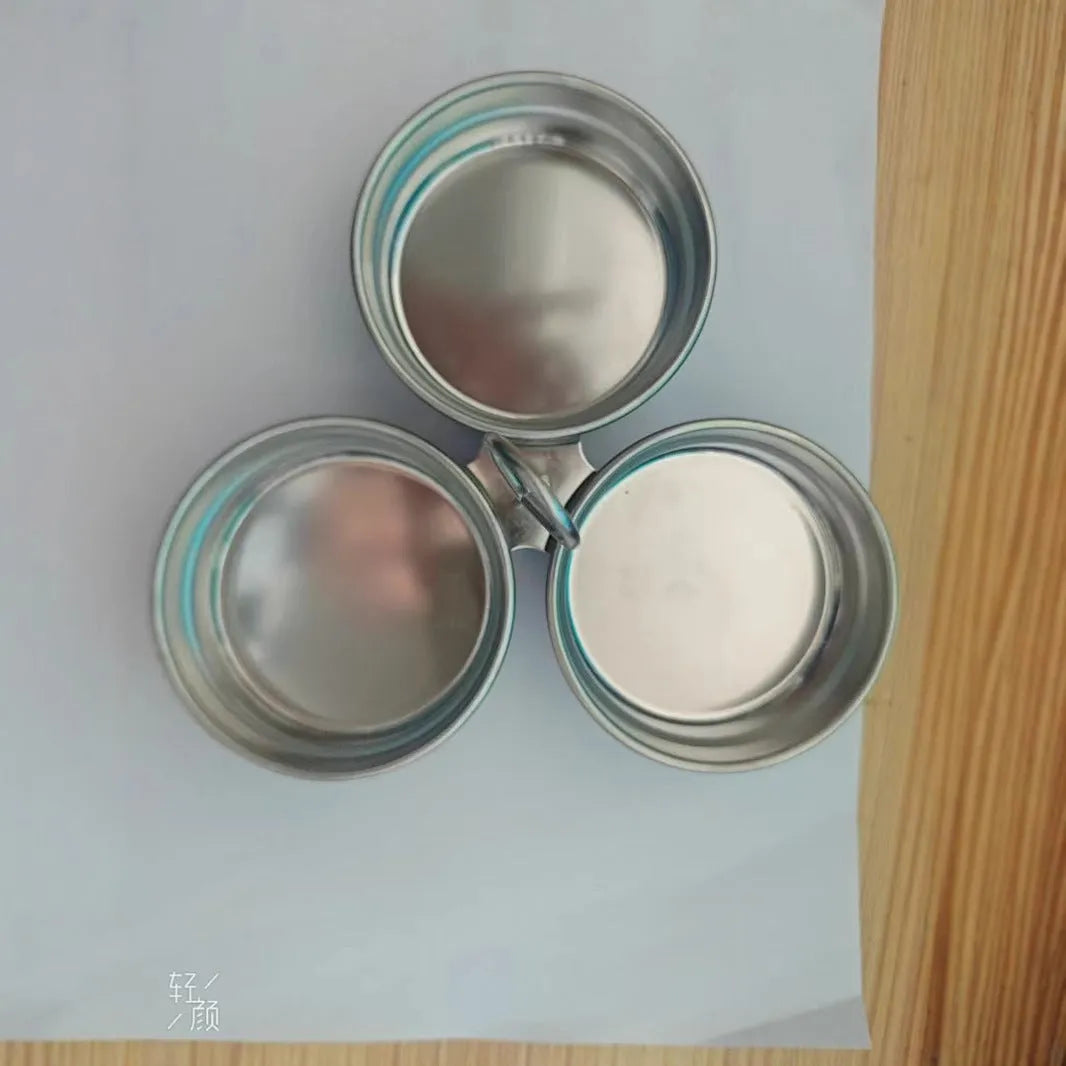 Small stainless steel egg steamer in both round and love-shaped designs on a kitchen counter.