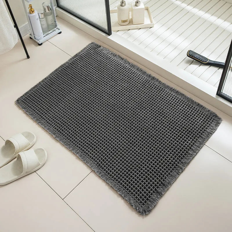 A square checkered pattern bathroom carpet with a non-slip backing in a neutral colour.