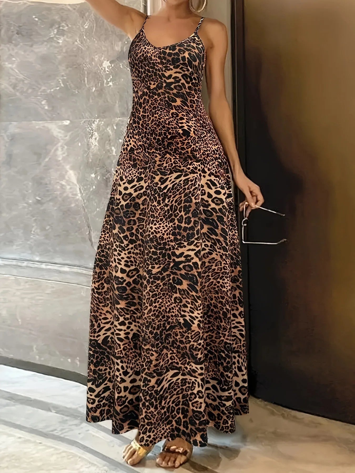 Dark brown leopard print women's dress with round neck, sleeveless design, and long hip skirt.