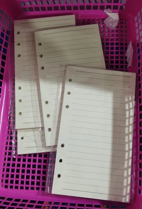 A5 6-hole loose-leaf refill with dot matrix ruling, 40 sheets of Daolin paper, displayed on a desk beside a ring binder