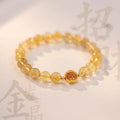 Gold rutilated quartz crystal bracelet with diamond-cut beads in a Korean-style design.