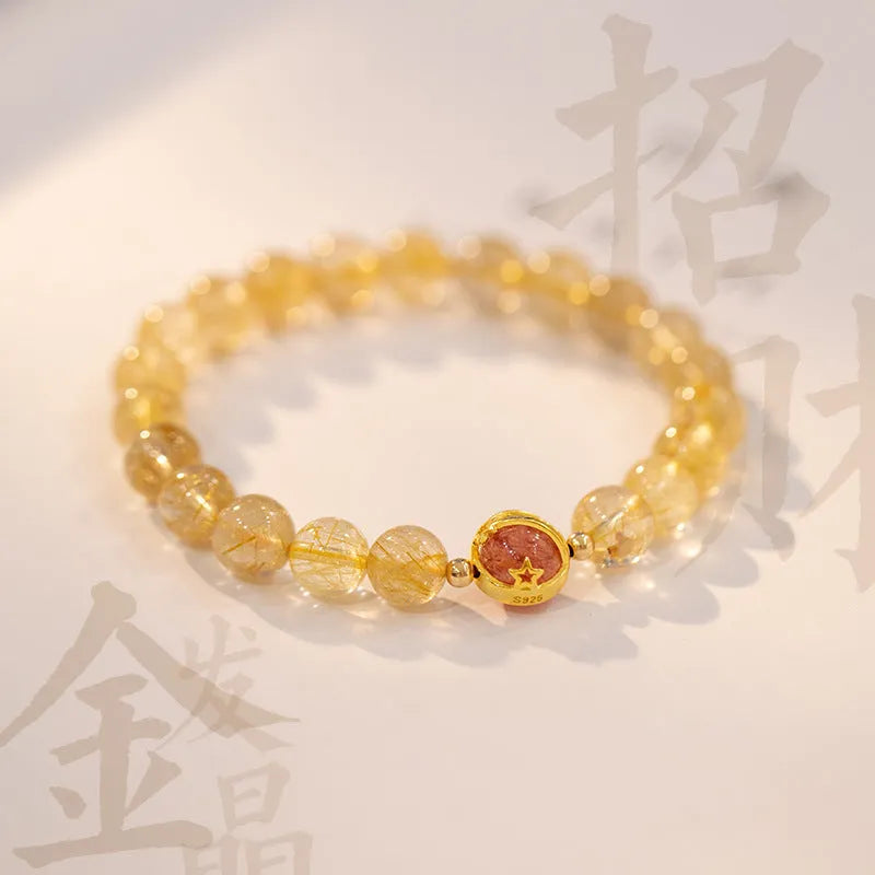 Gold rutilated quartz crystal bracelet with diamond-cut beads in a Korean-style design.