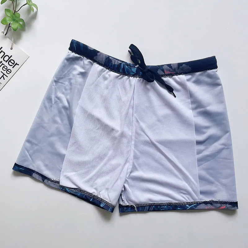 Men's loose fit anti-embarrassment swimming trunks in dark blue background big flower pattern, polyester fabric