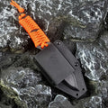 Straight blade outdoor survival knife with binding rope handle next to ABS plastic sheath