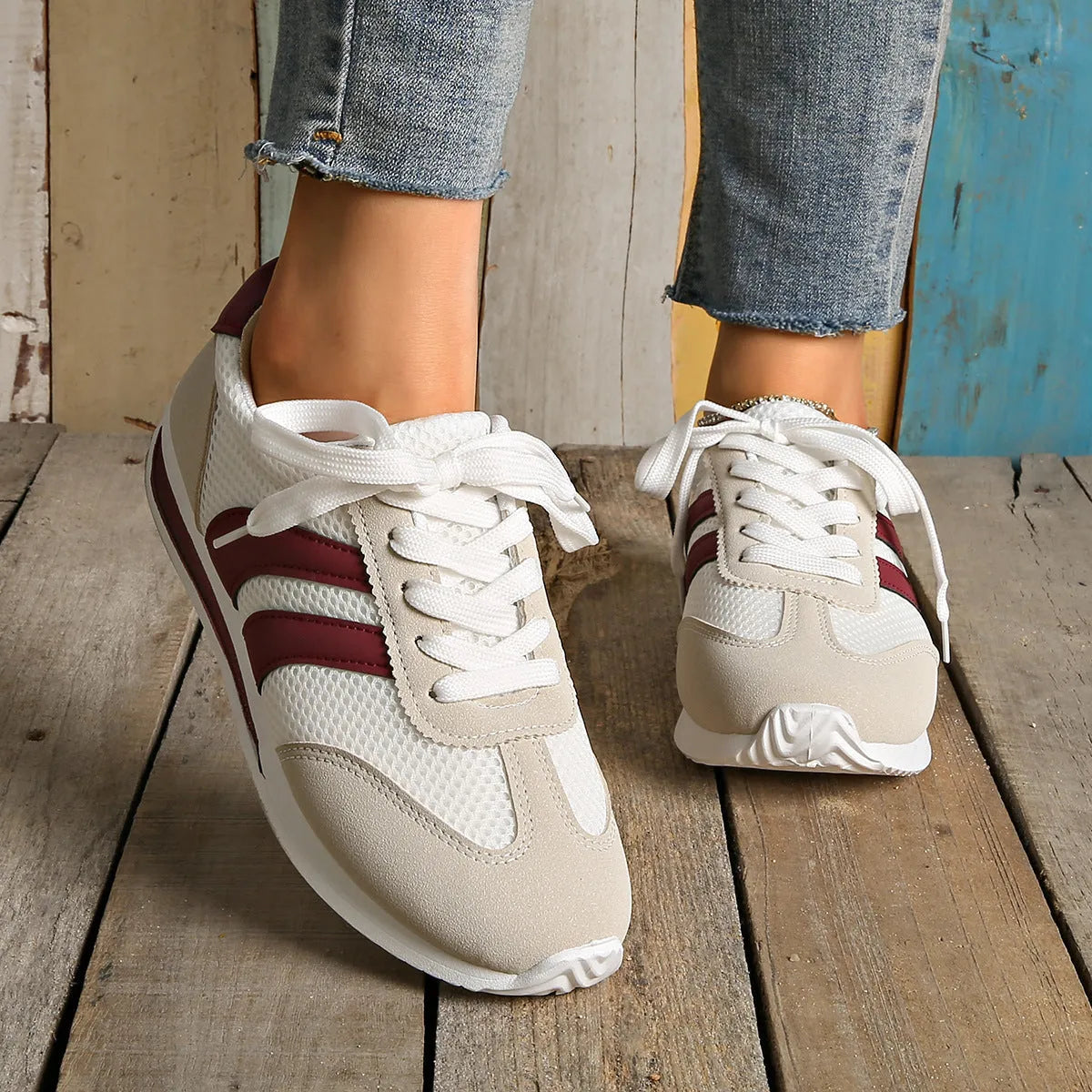 Wine red Cortez retro sneaker with cross strap and breathable mesh surface.