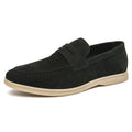 Men's beige leather slip-on shoes with a round toe and mid heel on a rubber sole.