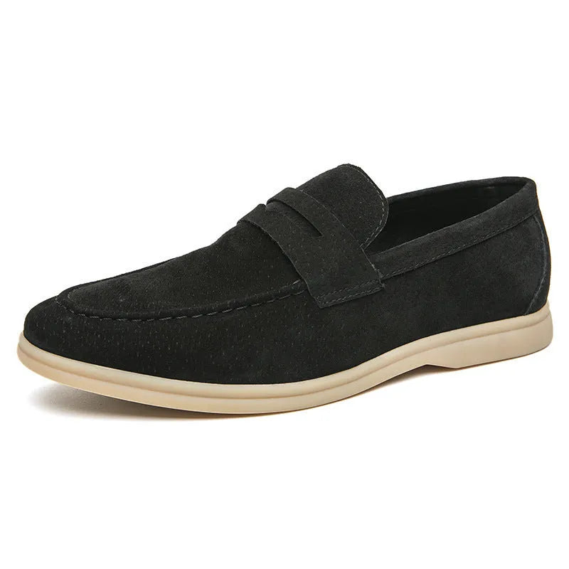 Men's beige leather slip-on shoes with a round toe and mid heel on a rubber sole.