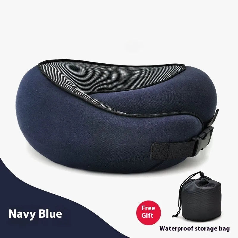 U-shaped navy blue travel neck pillow with memory foam, shown rolled up next to its carry bag.