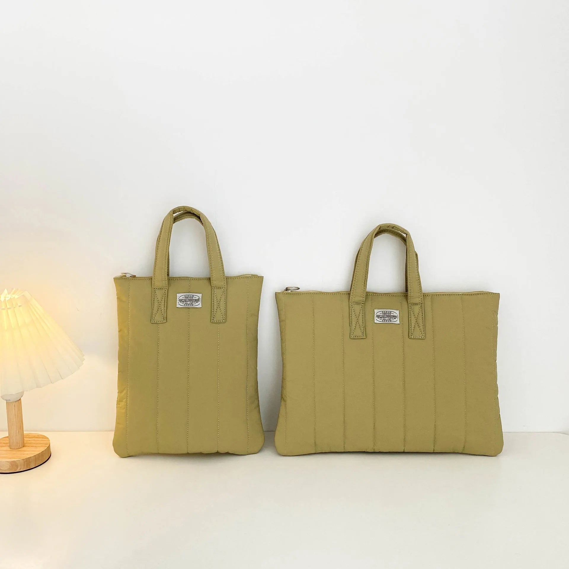 Personalised polyester laptop briefcase in milky white, shown with size options for 11, 13-14, and 15-15.6 inch devices.