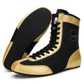 Professional black gold mesh boxing shoes with white leather panels and black detailing, shown in size 42.