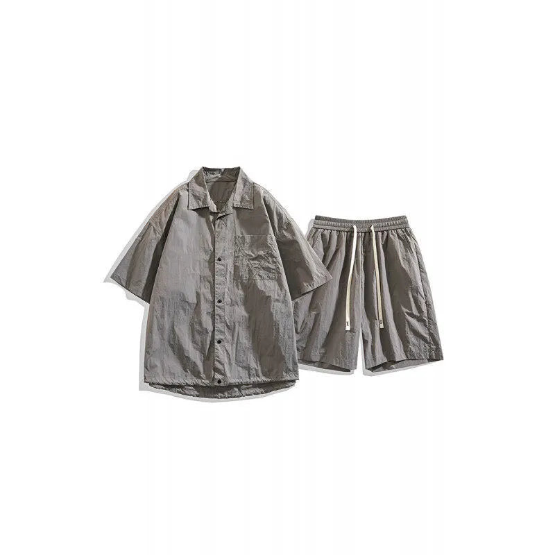 Man wearing a loose dark grey hemp-blend shirt and matching shorts casual two-piece set.