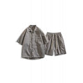 Man wearing a loose dark grey hemp-blend shirt and matching shorts casual two-piece set.