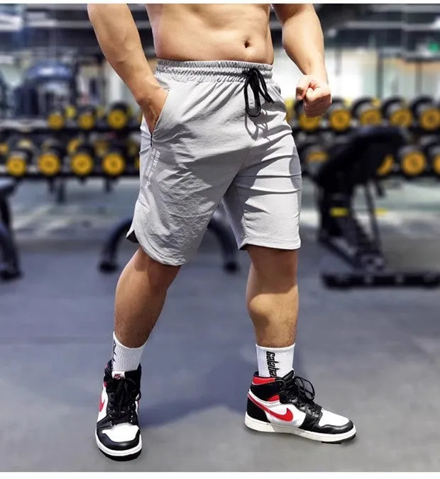Men's thin quick-drying running shorts in black, blue, or grey, made from nylon and spandex.