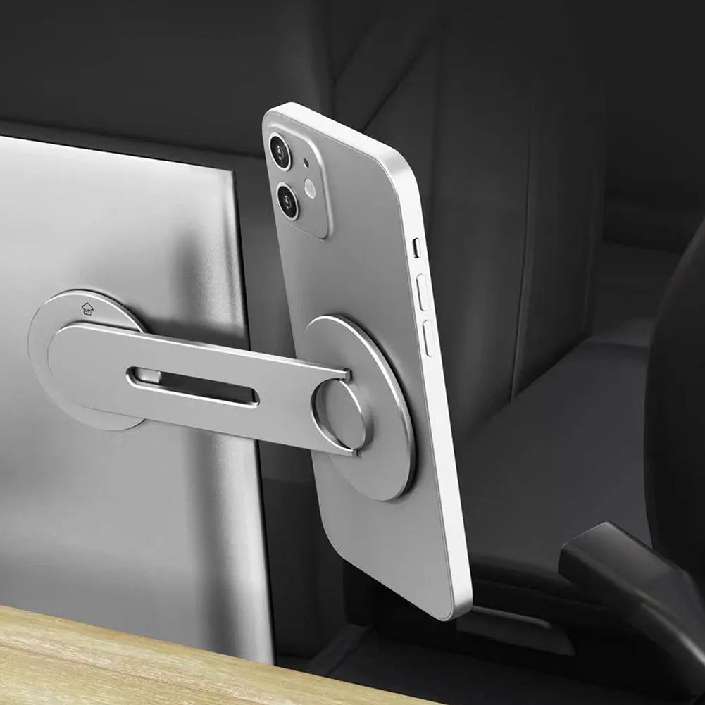 Silver aluminium alloy magnetic car phone holder mounted on Tesla suspension screen showing 180-degree flip capability
