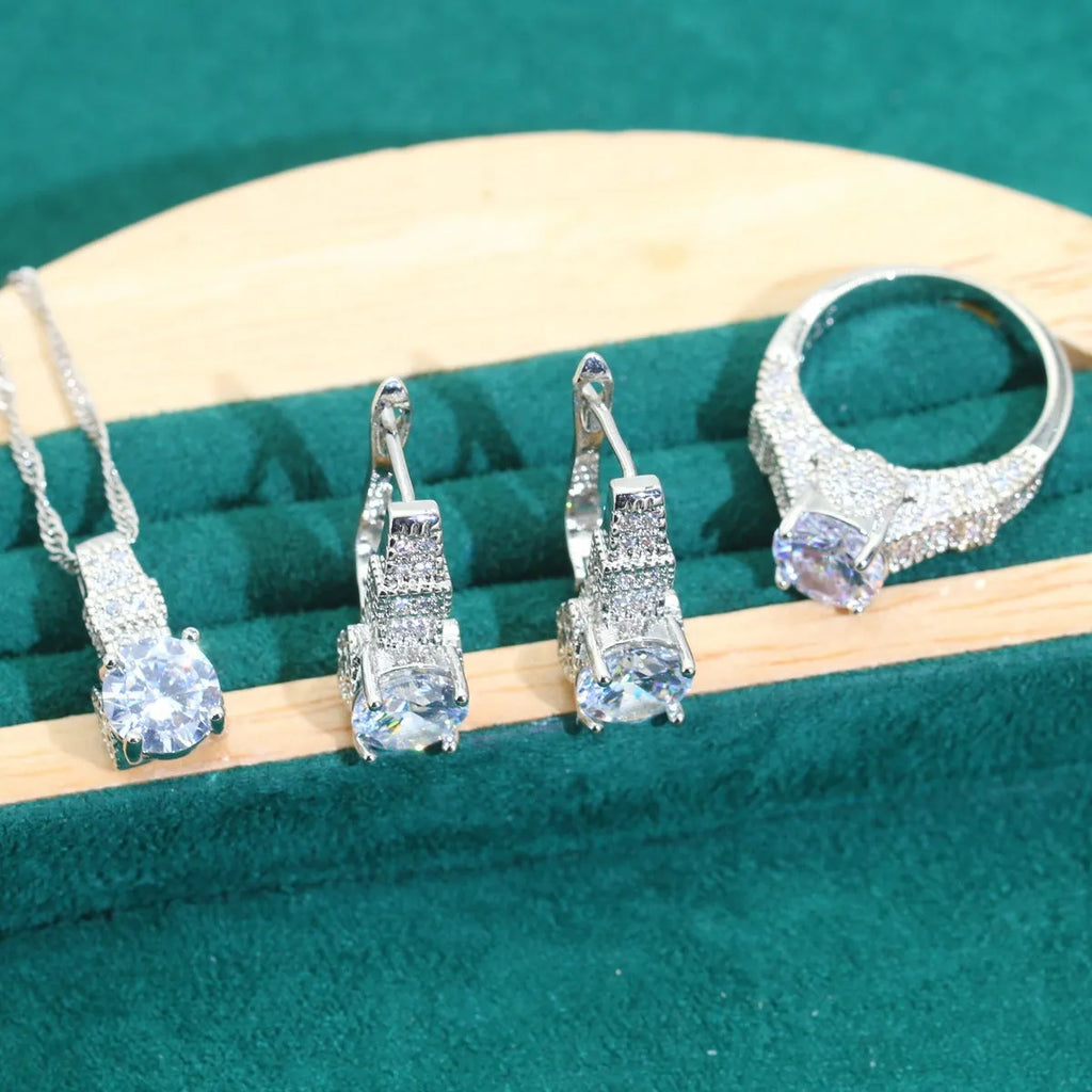 Zircon bridal jewellery four-piece set showing necklace, earrings, bracelet, and ring with alloy pendant
