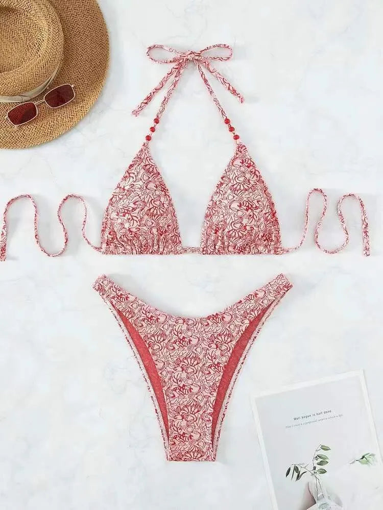 Women's floral pattern halter lanyard bikini set in emerald green, shown with top and shorts.