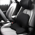 Car seat cushion with integrated memory foam waist pad and optional attached headrest in a neutral colour.