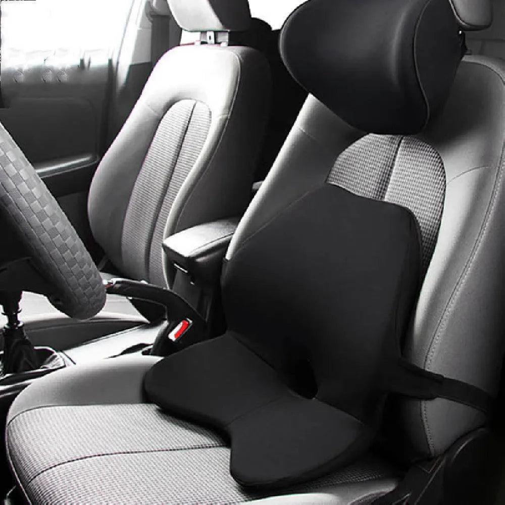 Car seat cushion with integrated memory foam waist pad and optional attached headrest in a neutral colour.