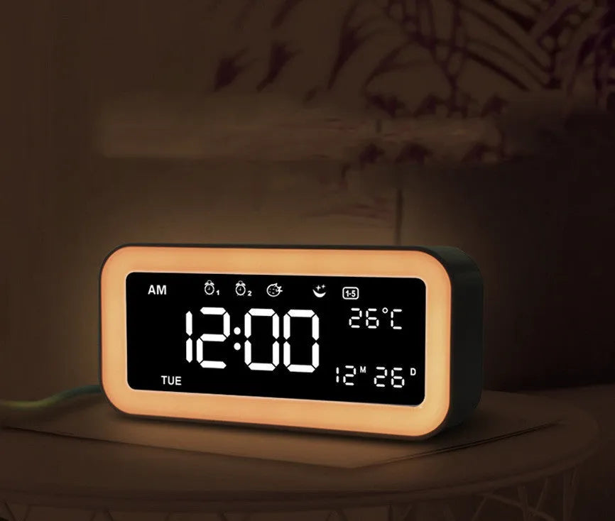 Blue rectangular multifunctional LED atmosphere light alarm clock with digital display on a wooden surface.