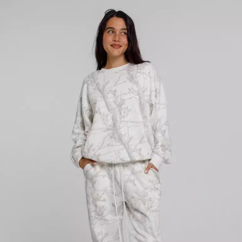 Stylish camouflage hoodie and sweatpants set with vibrant maple leaf print for athleisure fashion