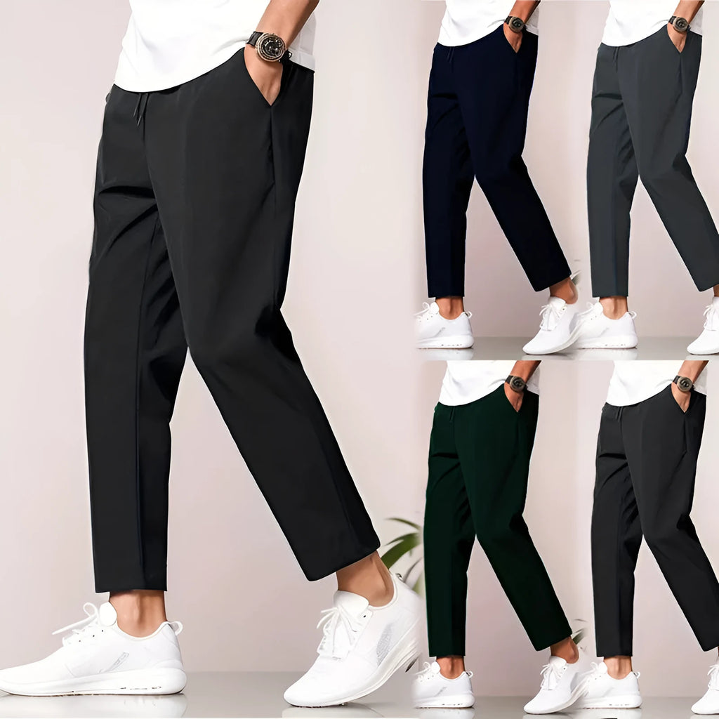 Men's slim fit ankle length trousers in black polyester, tapered leg, mid waist, cropped cut.