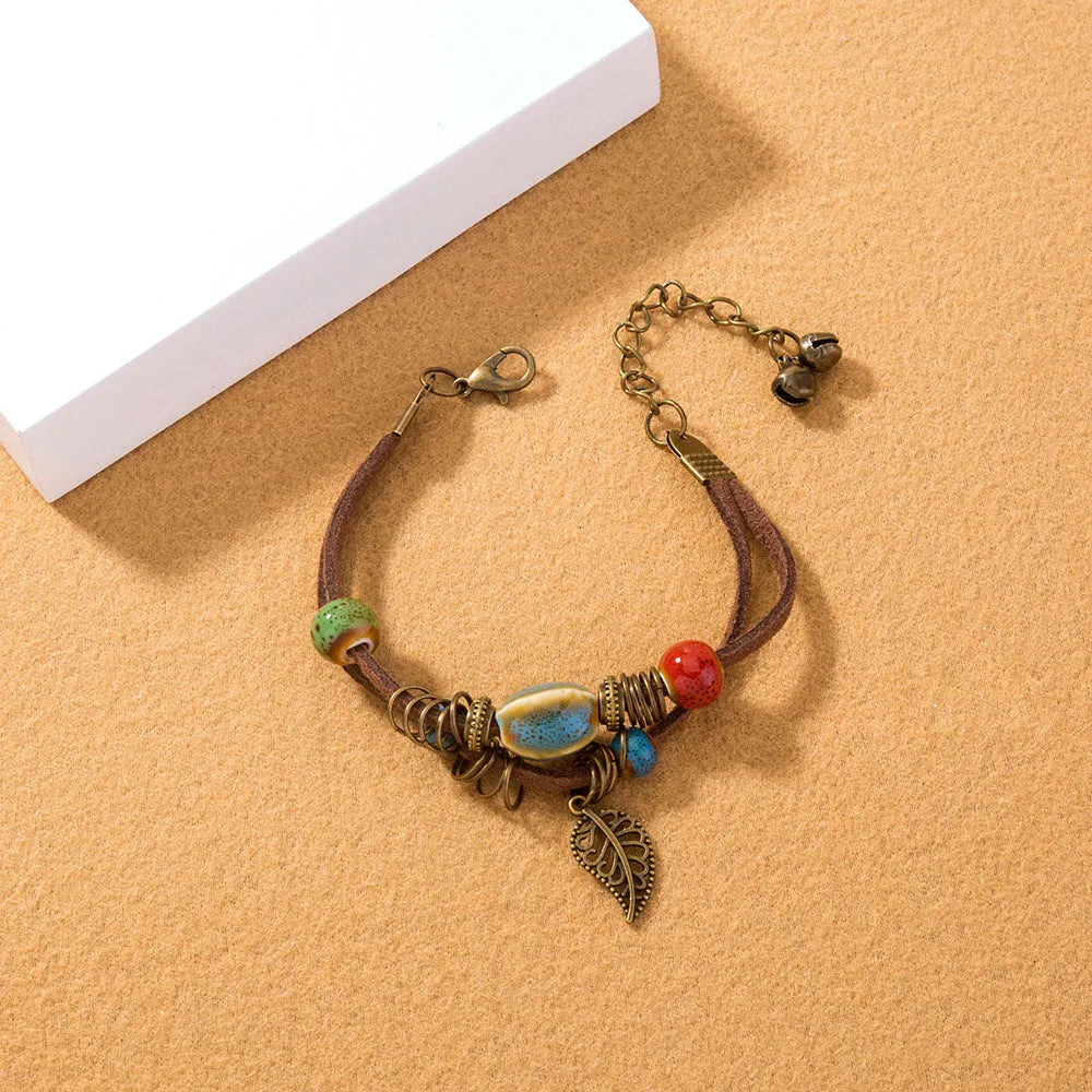 Hand-woven cowhide rope bracelet with ceramic beads in blue or white geometric bohemian style