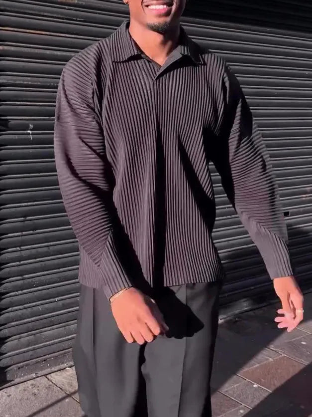 Men's black polyester long-sleeved top with pleated design detail showing regular fit and long sleeves