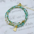 Korean style adjustable bracelet with turquoise round beads and a three-ring pull-out clasp.