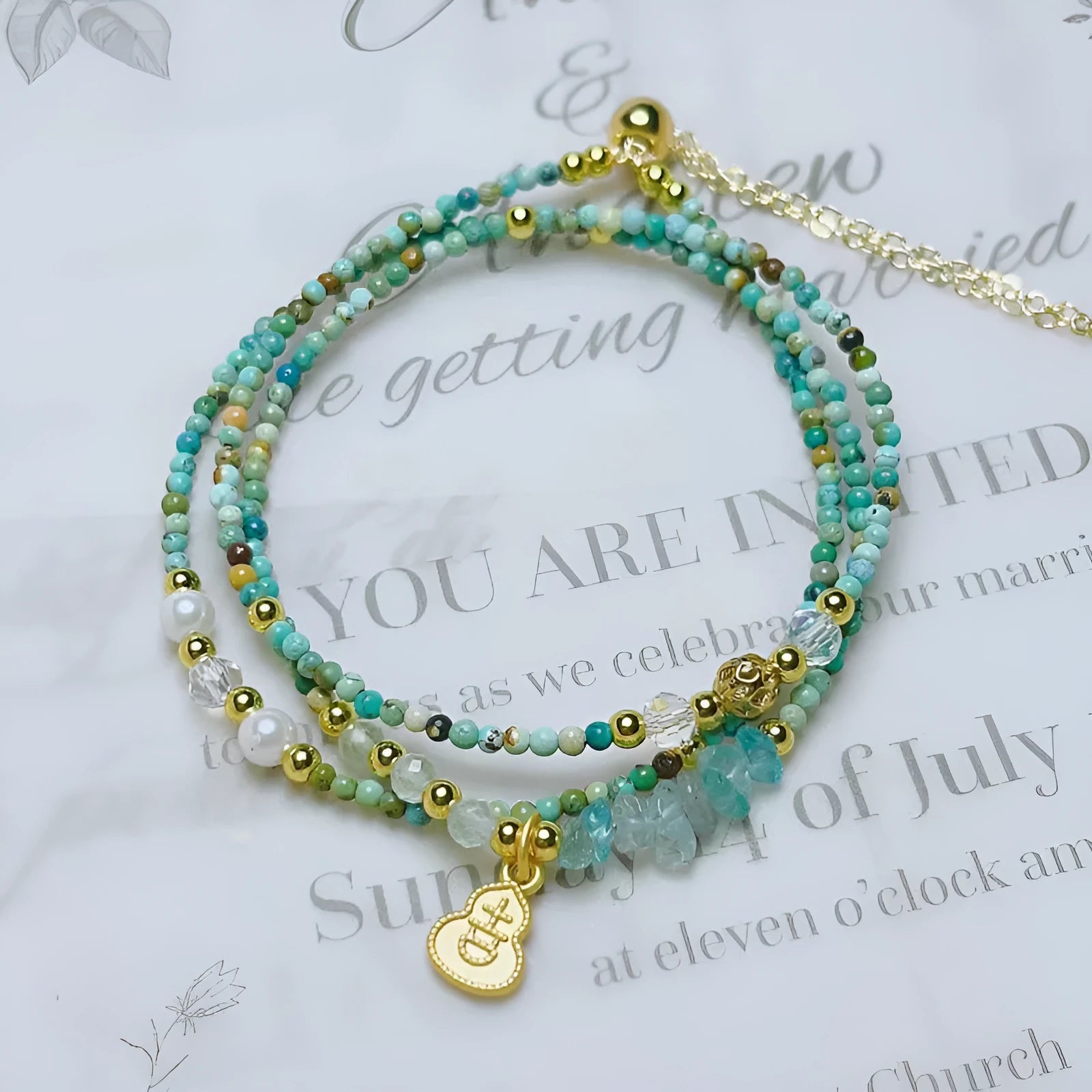 Korean style adjustable bracelet with turquoise round beads and a three-ring pull-out clasp.