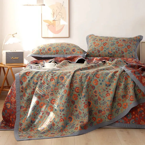 Three-piece cotton gauze bed blanket set with floral pattern showing blanket and two pillowcases