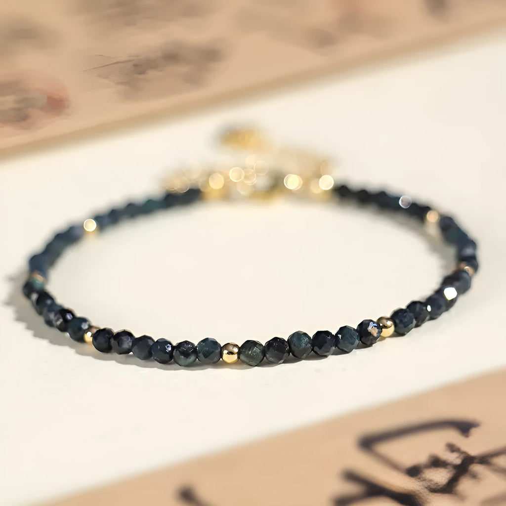 Blue tourmaline beaded bracelet with spacer beads on wrist showing 3mm gemstone size