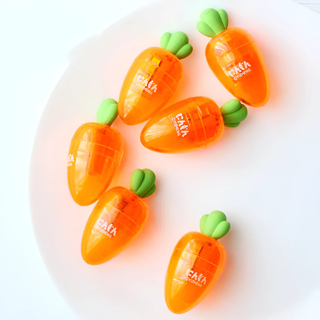 Orange carrot-shaped plastic pencil sharpener with green top, 7cm total length