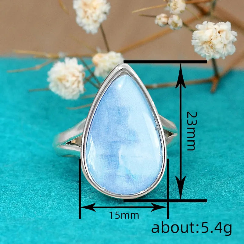 Women's copper drop-shaped geometric ring in electroplated A077 white gold colour, side view on white background