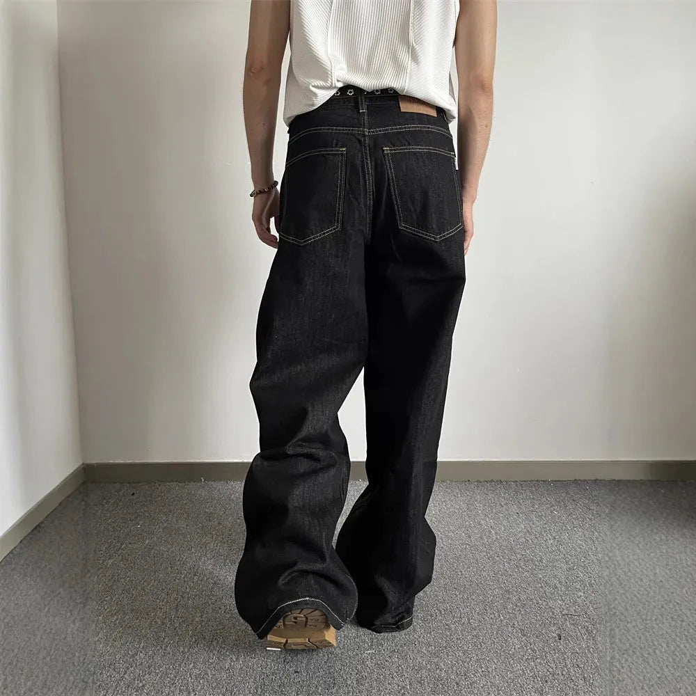 Black retro-style loose-fit straight-leg denim jeans on a hanger.