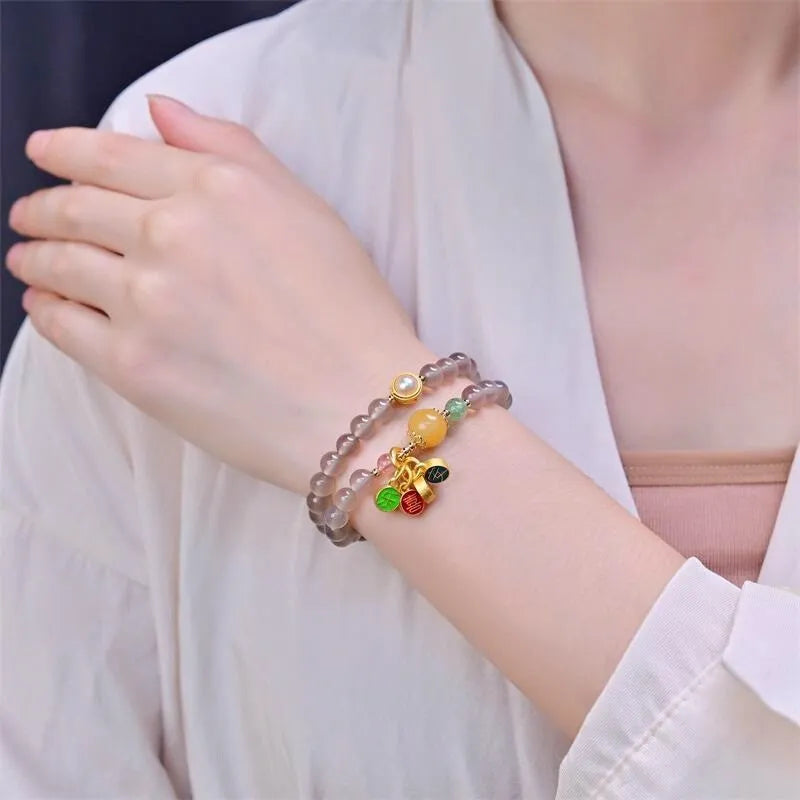 Close-up of a natural grey agate two-circle bracelet with retro design on a wrist.