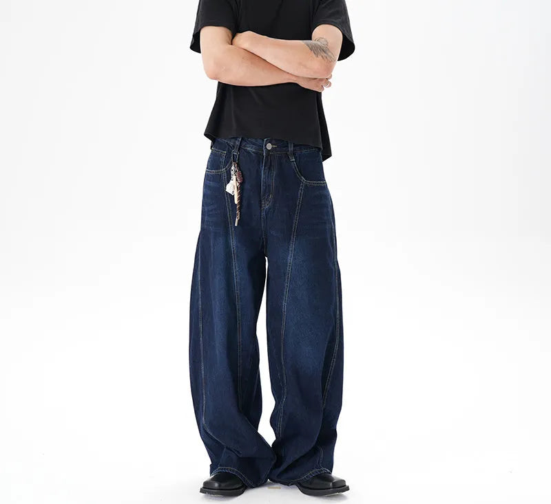 Dark blue wide leg distressed jeans on a hanger showing washed denim fabric and machete cut.