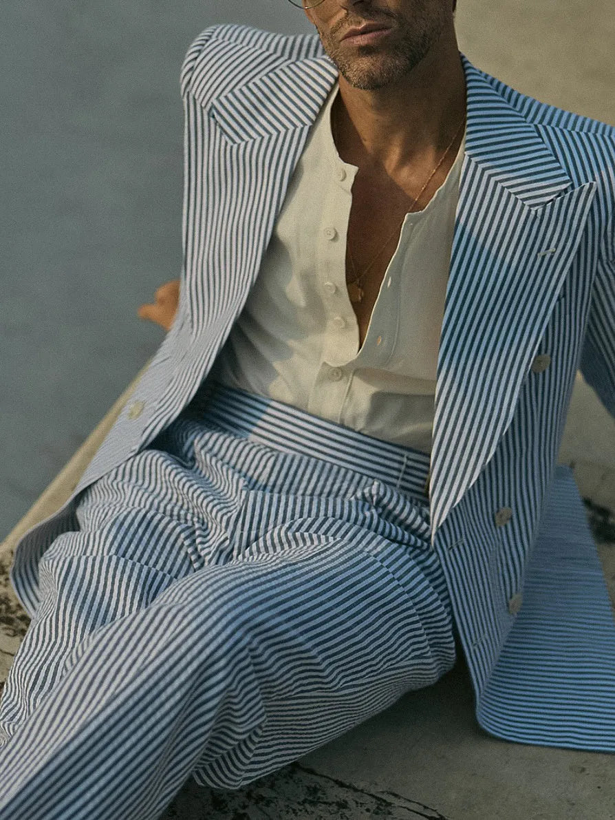 Blue and white striped women's blazer and trouser suit set on a hanger