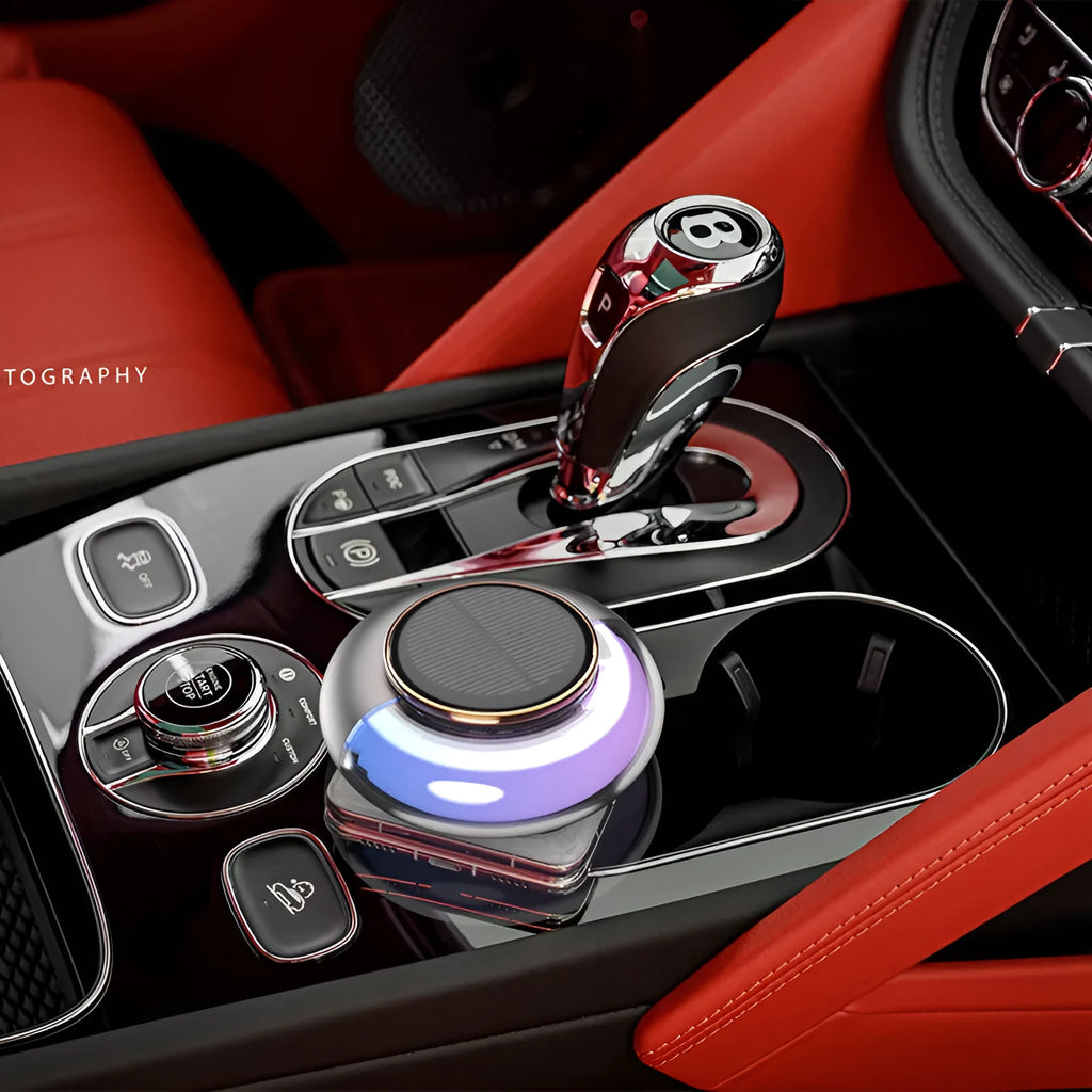 Car solar charging fragrance with built-in motor, round shape, grey colour, on car dashboard