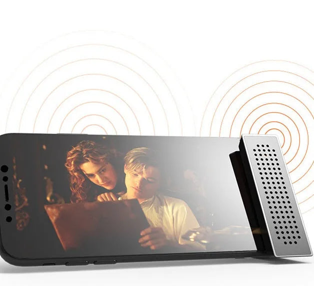 Mini black ABS plastic mobile phone amplifier bracket holding an iPhone on a desktop.