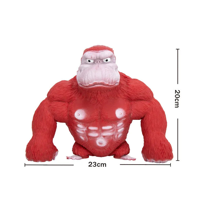 Yellow plastic orangutan decompression squeeze toy for stress relief on a plain background