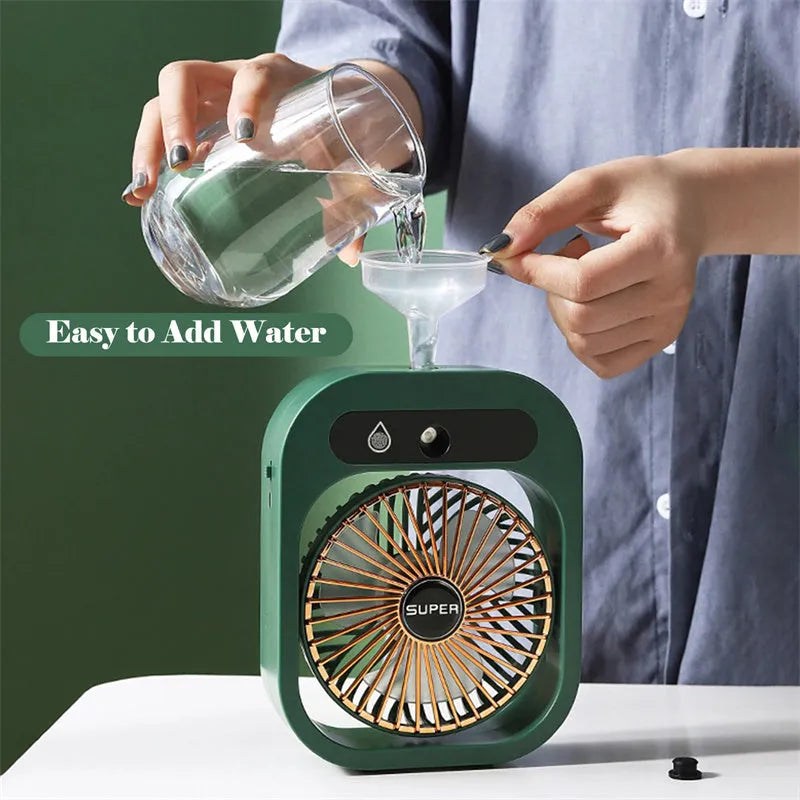 Green and white USB portable misting fan humidifier on a desk showing adjustable vent and water tank.