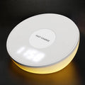 White wireless charger with clock display and three control buttons for mobile phone charging