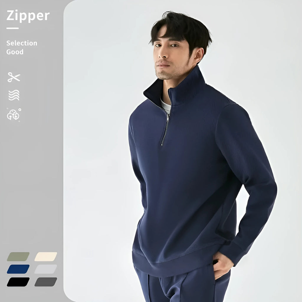 Man wearing a grey zip-front stand collar cotton sports sweater with a straight cut for casual wear.