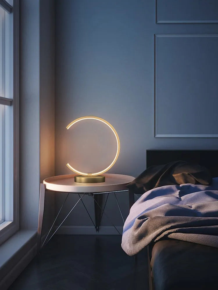 All copper Nordic style table lamp with tri-tone LED light, push button switch, on a wooden desk