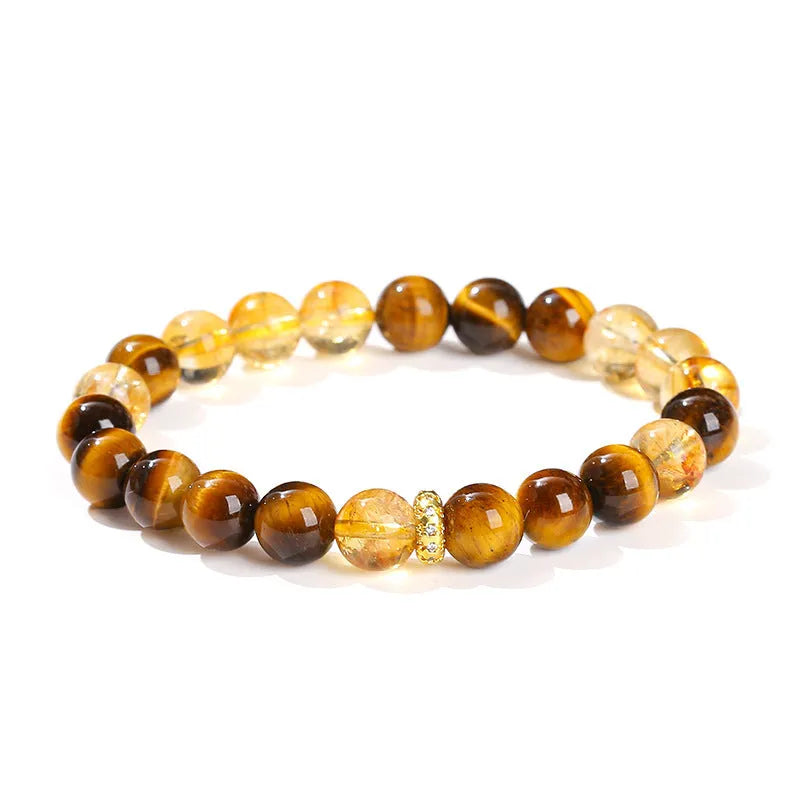 Women's geometric bracelet with natural yellow tiger stone and yellow tower crystal beads on wrist.
