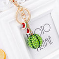 Green zinc alloy watermelon-shaped keychain measuring 12 cm.
