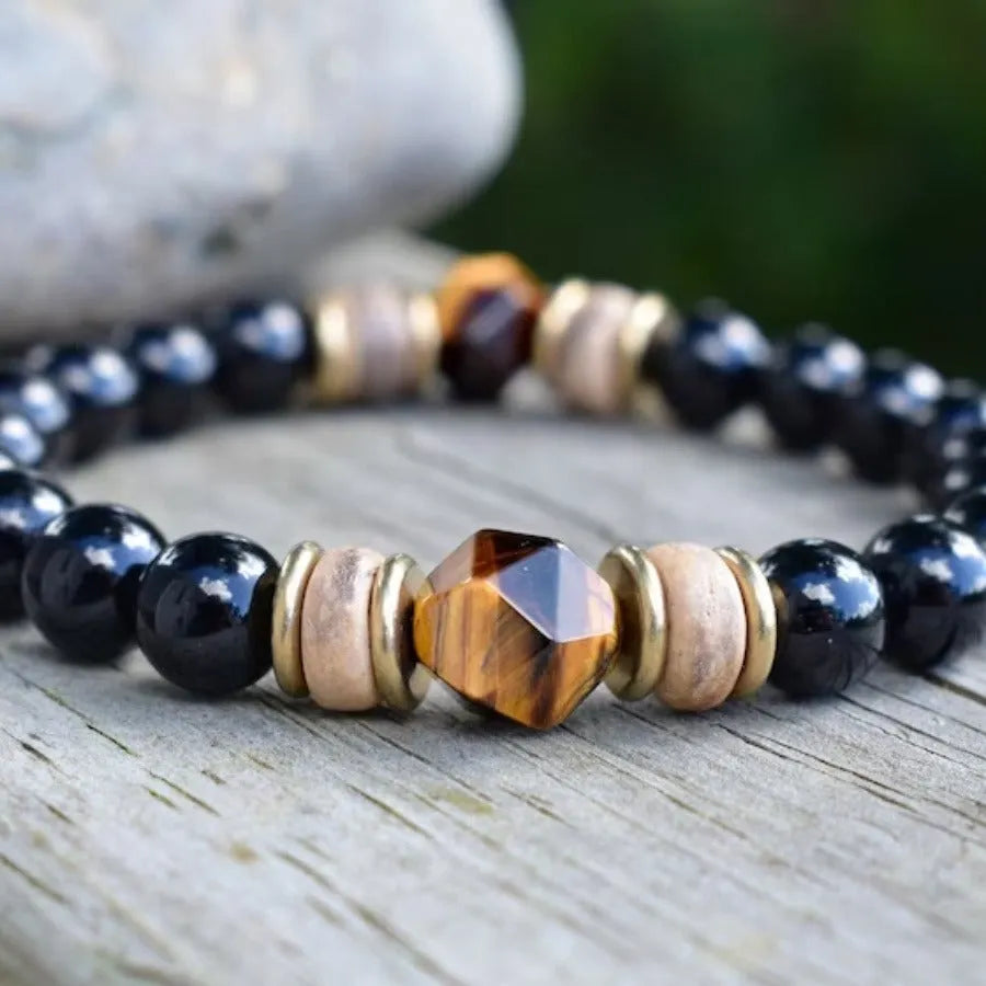 Tigereye cut obsidian bracelet with 8mm black beads on neutral background