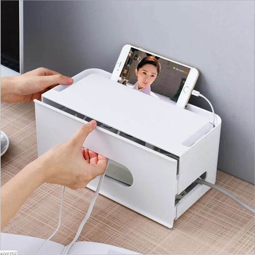 Grey and white plastic router storage box with cable ports for home cable management