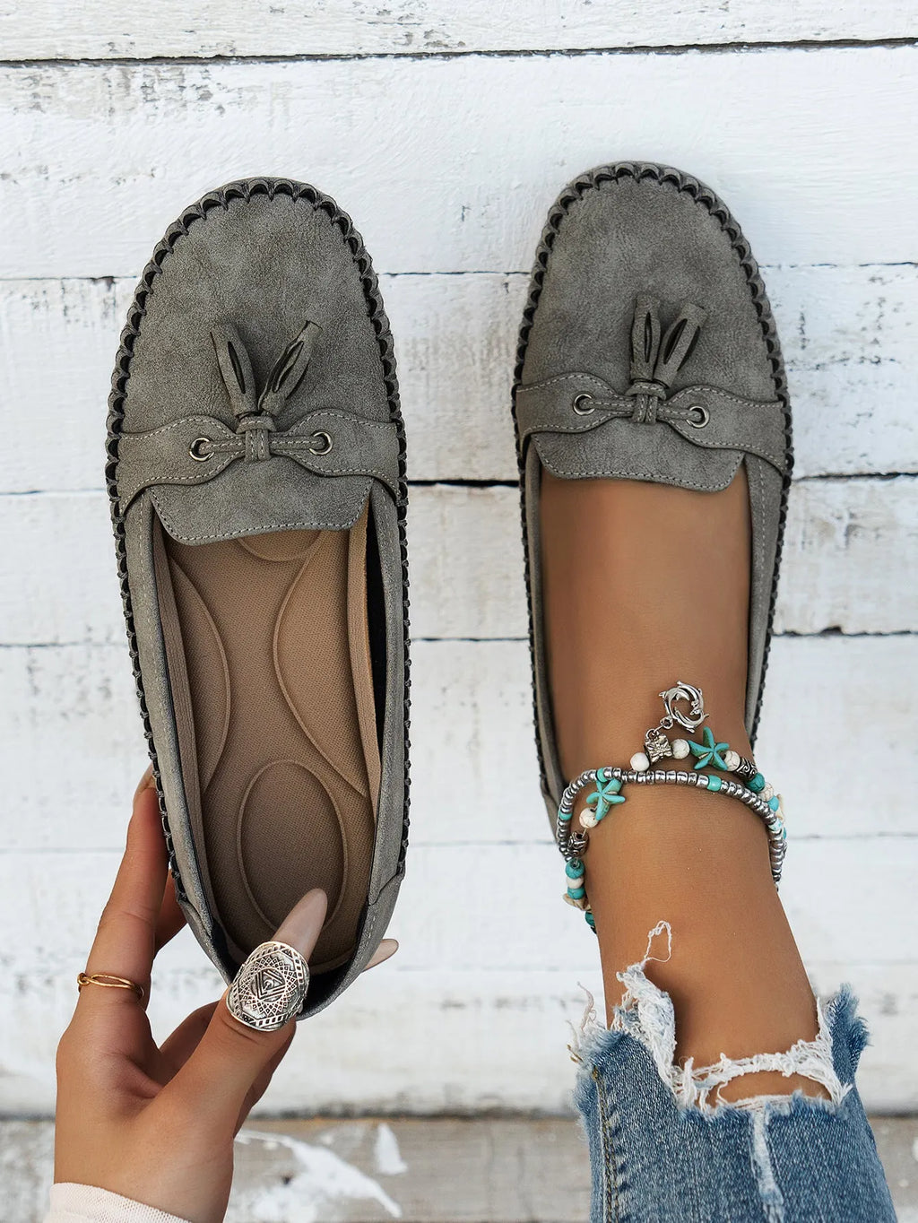 Women's suede flat shoes with a bow, shown in pink, apricot, grey, and blue colour options.